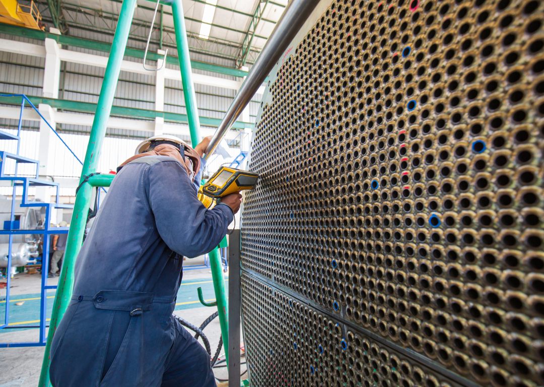 Shop technician inspecting a firetube bundle